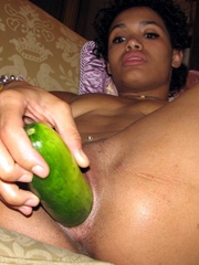 Young ebony girl shoves vegetable..